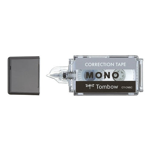 Tombow Mono correction tape with black cap shown next to size reference object displaying scale and compact design