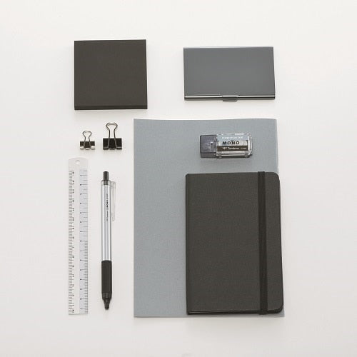 Tombow Mono correction tape with office supplies flatlay showing scale and usage context with notebook and stationery