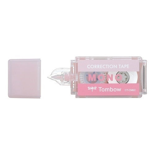 Tombow Mono Pocket correction tape with cap removed, showing pink dispenser and applicator tip next to dust cover.