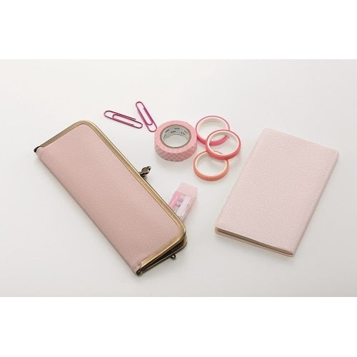 Pink correction tape with wallet and notebook, showing product scale and styling with matching accessories