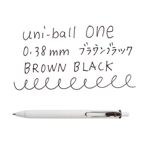 Uni-ball One 0.38mm brown black pen with writing samples showing pen tip detail and line quality on white background