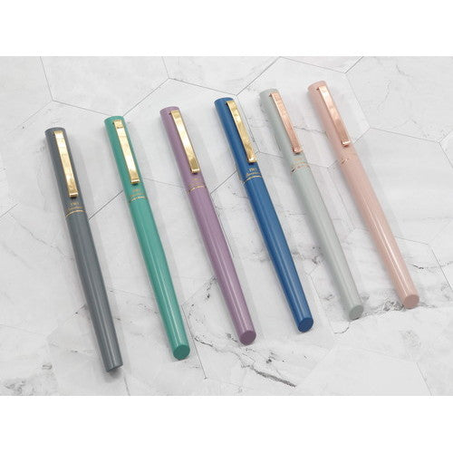 InterAct Rollerball Pen collection showing all six color options including soft pink, displayed on marble surface for color…
